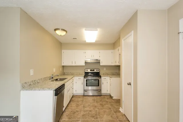 a kitchen with stainless steel appliances granite countertop a stove and a refrigerator