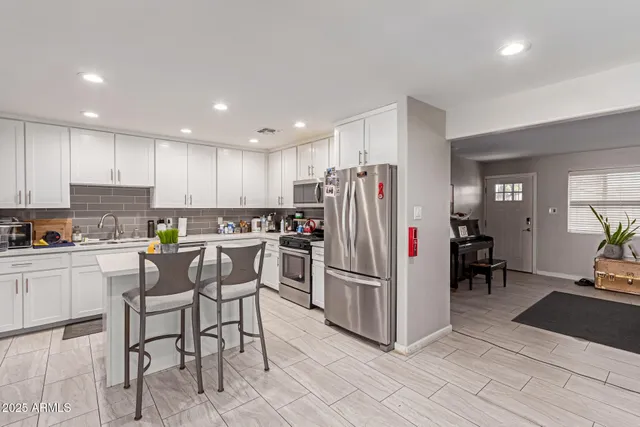 a kitchen with refrigerator cabinets and dining table