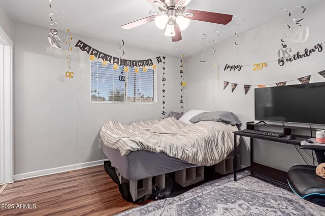 a bedroom with bed and a flat screen tv