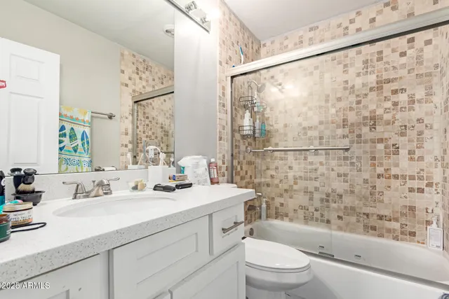 a bathroom with a sink a toilet and shower curtain