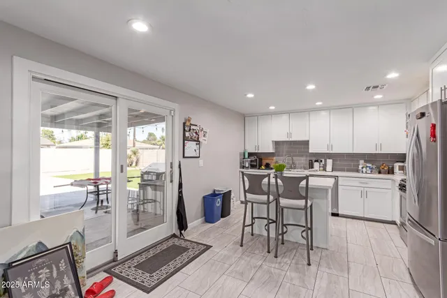 a kitchen with a table and chairs