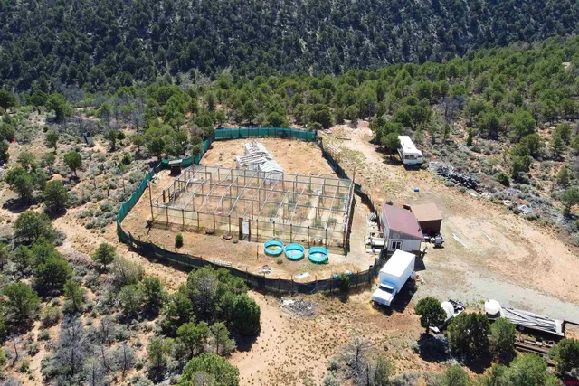 an aerial view of a house with a yard basket ball court and outdoor seating