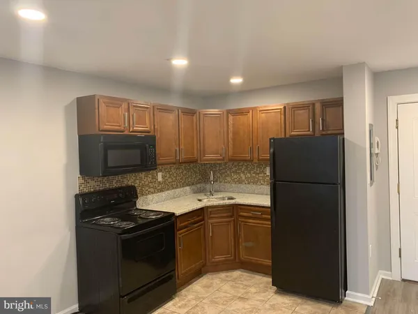 a kitchen with a refrigerator stove and microwave