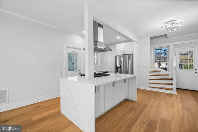 a view of kitchen with cabinets and wooden floor