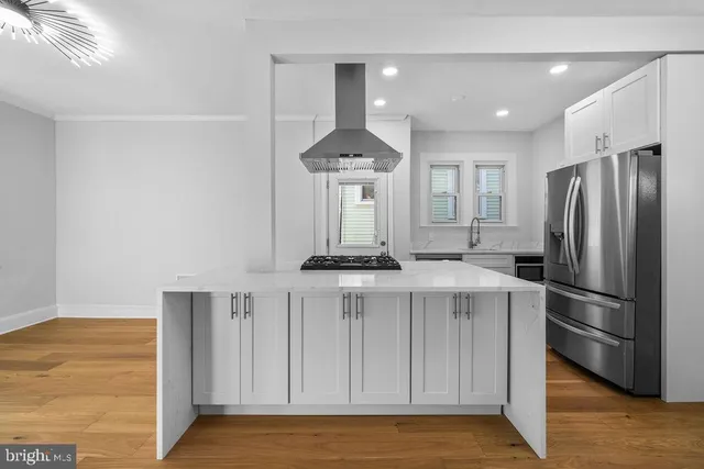 a kitchen with stainless steel appliances a refrigerator and a stove