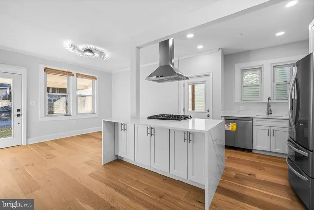 a kitchen with a sink stainless steel appliances and cabinets