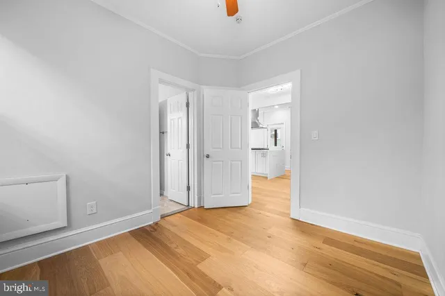 a view of empty room with wooden floor