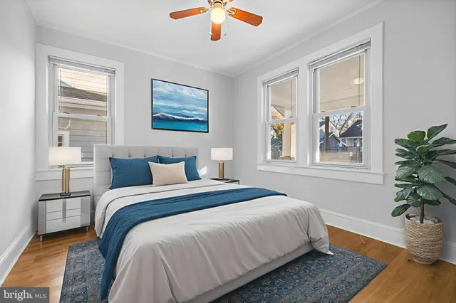 a bedroom with bed and wooden floor