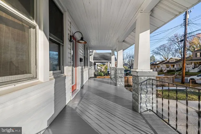 a view of a porch with wooden floor and iron stairs