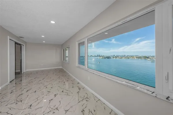 a view of a balcony with wooden floor & fence