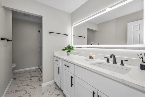 a kitchen with cabinets appliances a sink and a counter space