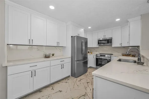 a view of a big room with wooden floor and windows