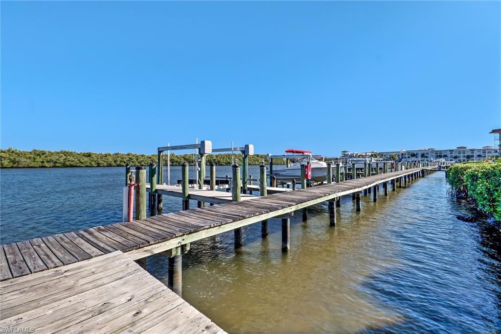 305 Goodlette Road South, Unit C302 Naples, FL 34102 - Photo 21 of 22 a view of ocean with boats and trees in the background