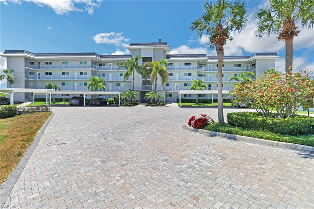 305 Goodlette Road South, Unit C302 Naples, FL 34102 - Photo 3 of 22 a view of a house with a yard and potted plants
