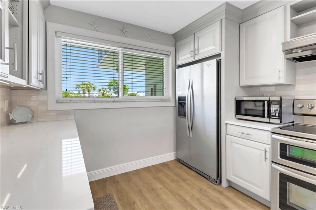 305 Goodlette Road South, Unit C302 Naples, FL 34102 - Photo 5 of 22 a kitchen with a refrigerator and window