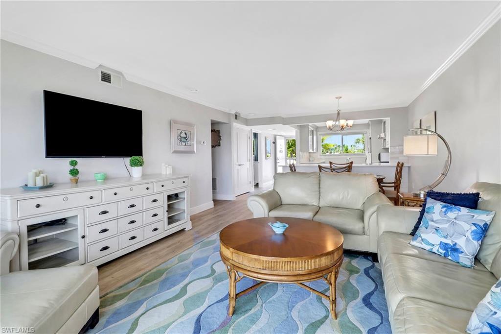 305 Goodlette Road South, Unit C302 Naples, FL 34102 - Photo 9 of 22 a living room with furniture and a flat screen tv