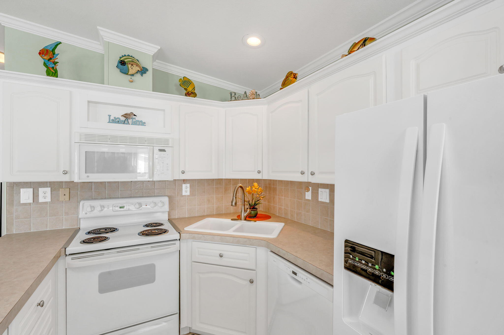 55 Boca Chica Road, Unit 447 Key West, FL 33040 - Photo 6 of 51 a kitchen with a sink a stove and cabinets