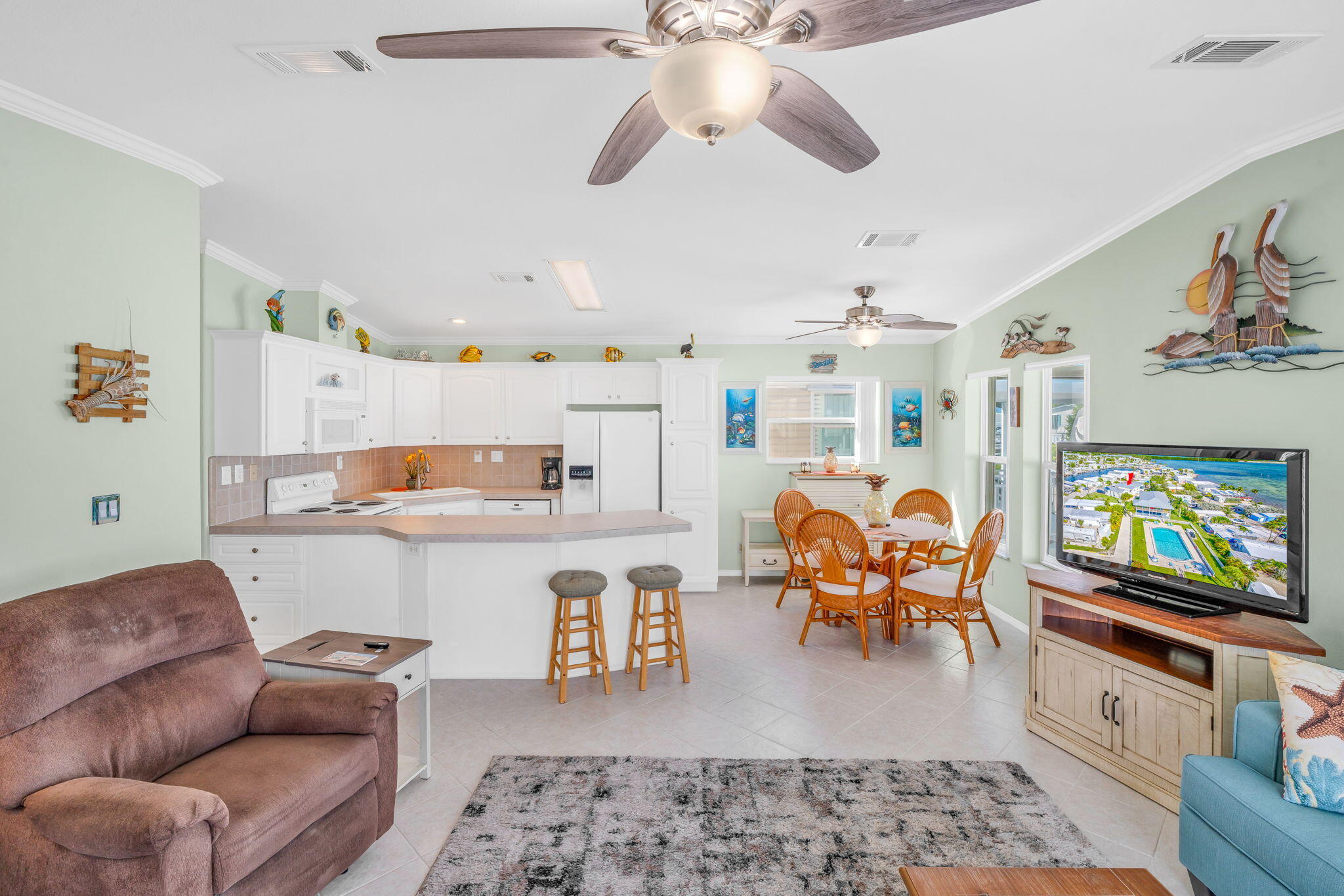 55 Boca Chica Road, Unit 447 Key West, FL 33040 - Photo 45 of 51 a living room with furniture and a flat screen tv