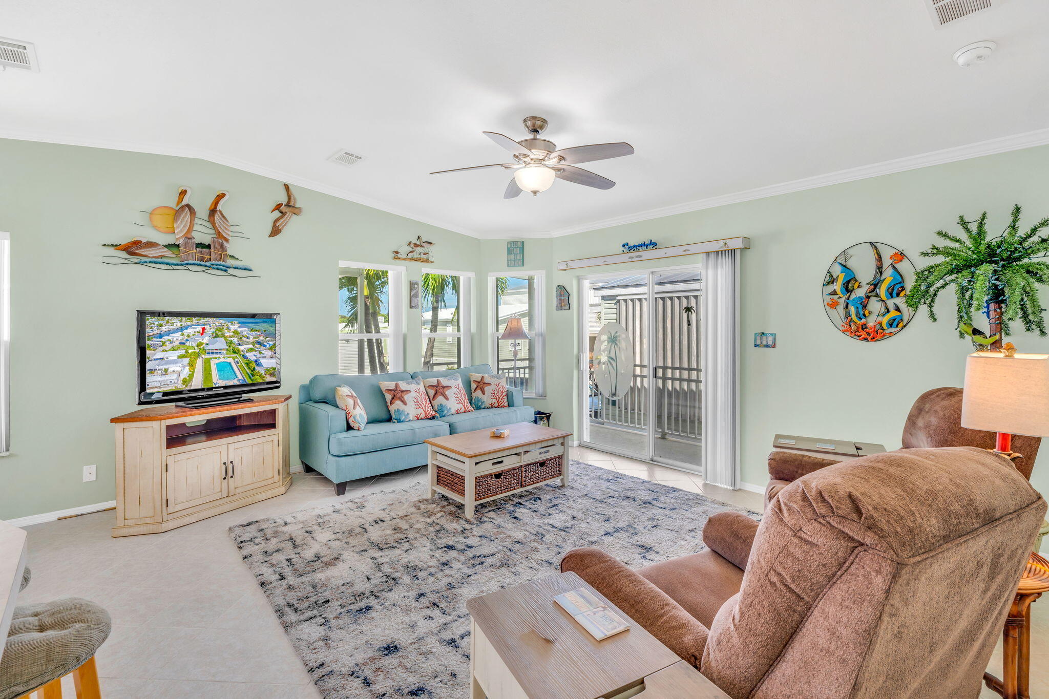 55 Boca Chica Road, Unit 447 Key West, FL 33040 - Photo 49 of 51 a living room with furniture and a flat screen tv