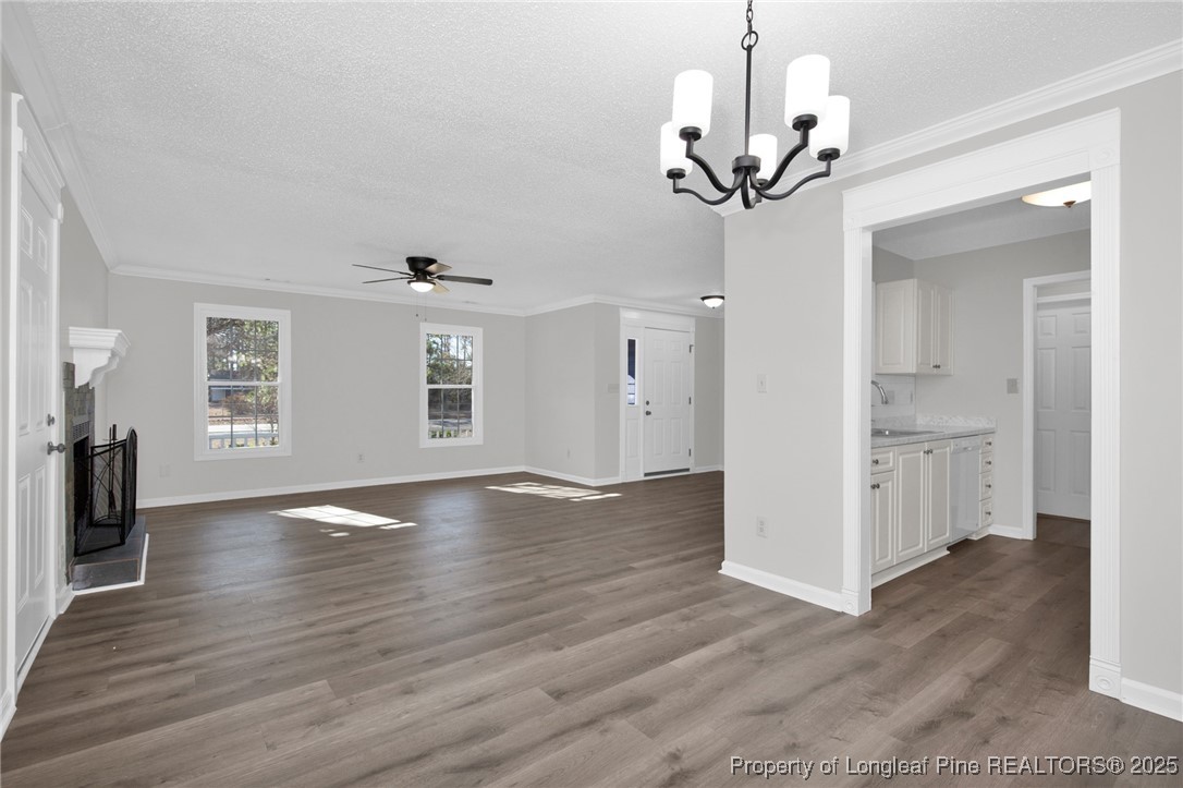 501 Camden Road Raeford, NC 28376 - Photo 11 of 35 a view of a livingroom with wooden floor and a ceiling fan