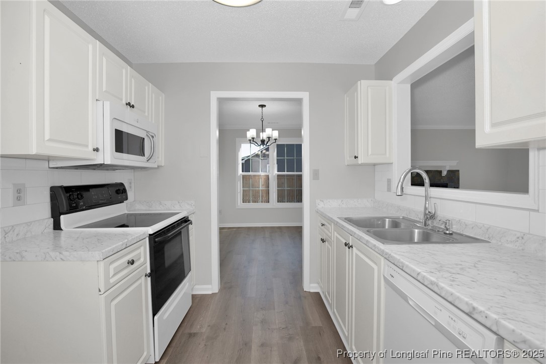501 Camden Road Raeford, NC 28376 - Photo 16 of 35 a kitchen with a sink stove and cabinets