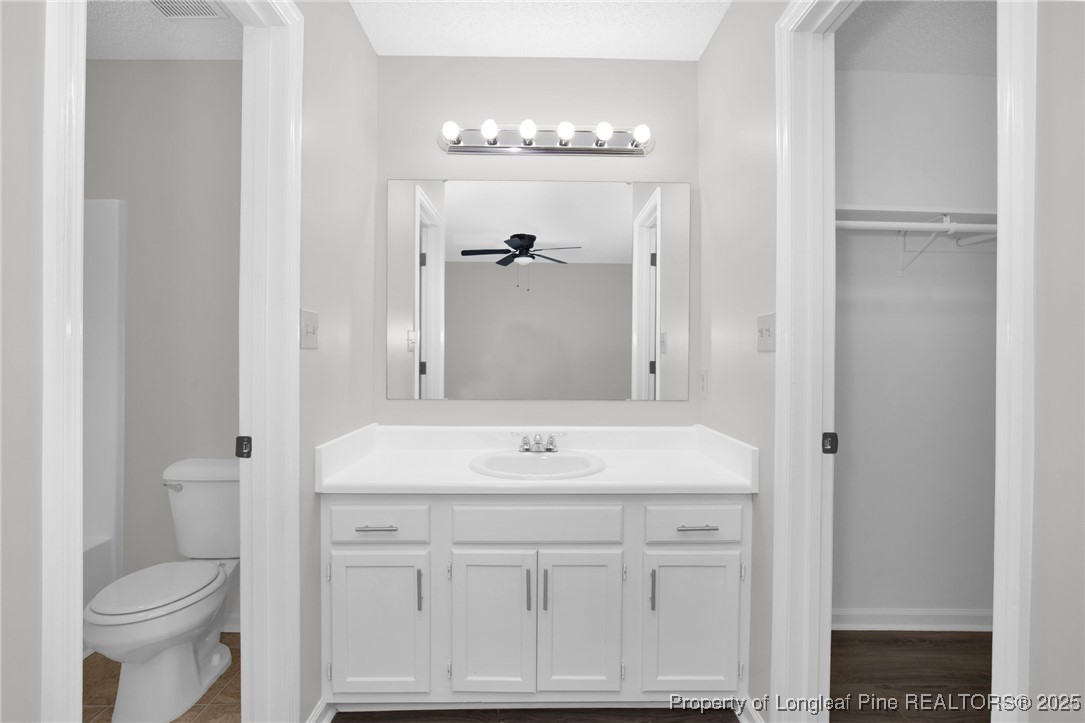 501 Camden Road Raeford, NC 28376 - Photo 25 of 35 a bathroom with a sink a toilet and a mirror