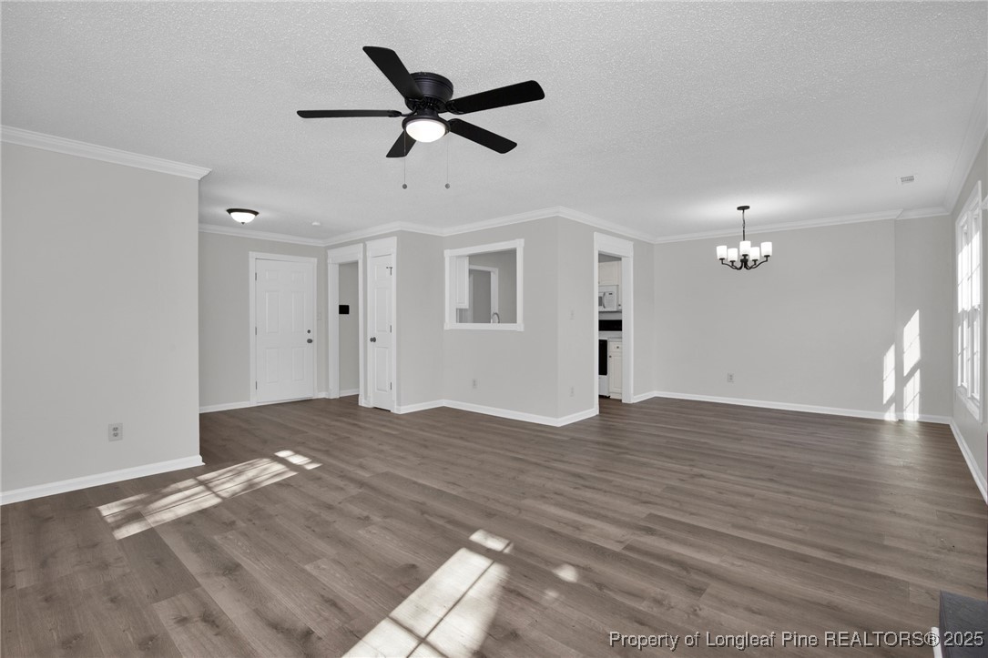 501 Camden Road Raeford, NC 28376 - Photo 8 of 35 a view of a big room with wooden floor and a ceiling fan