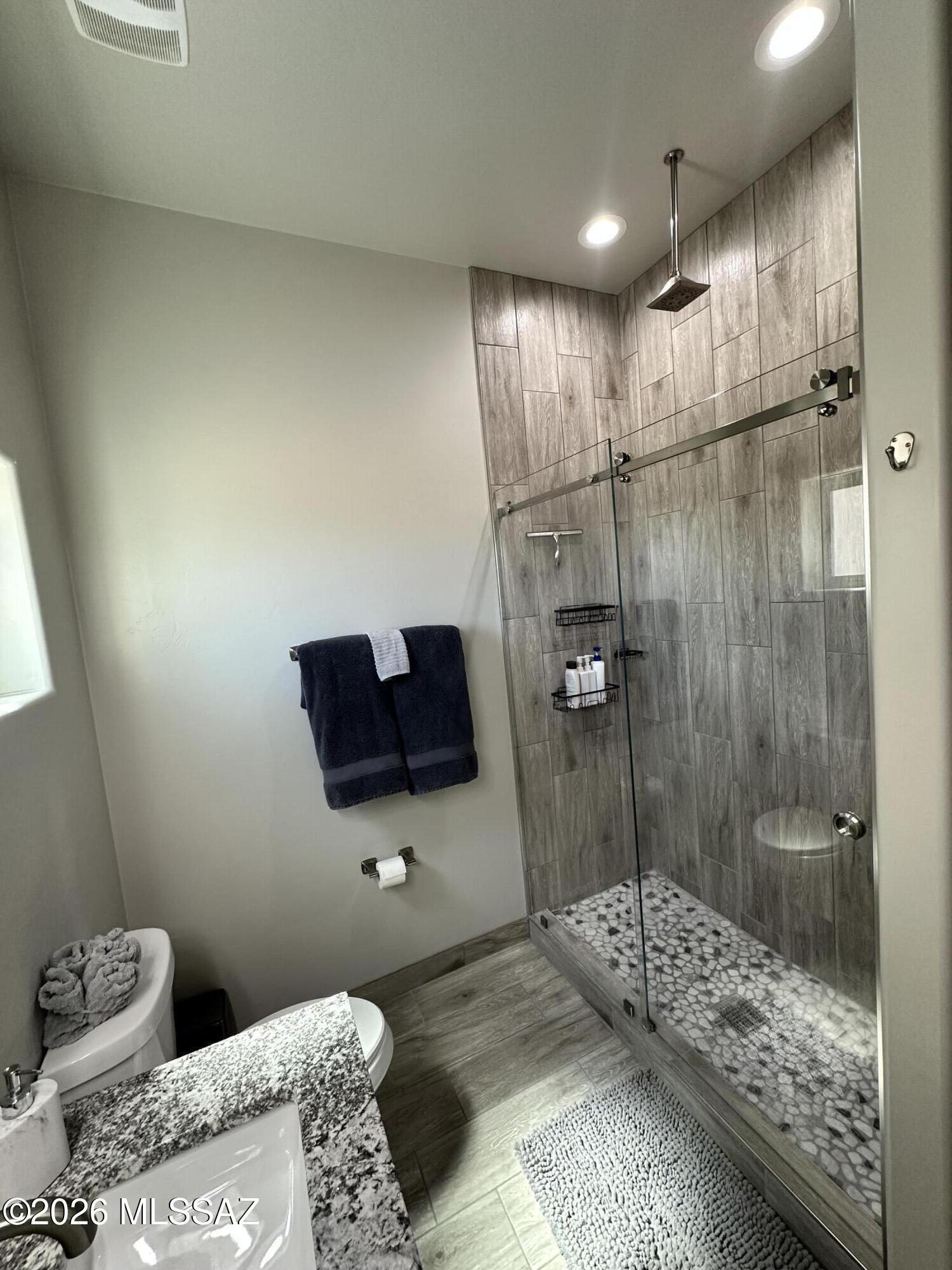 117 Ver Patria Rio Rico, AZ 85648 - Photo 23 of 28 a bathroom with a granite countertop sink mirror and shower