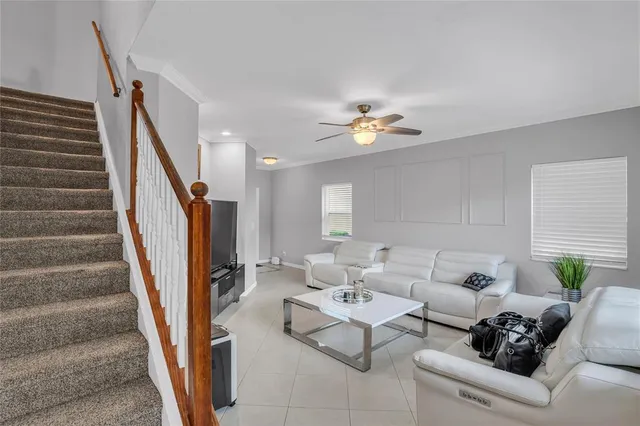 a living room with furniture and stairs