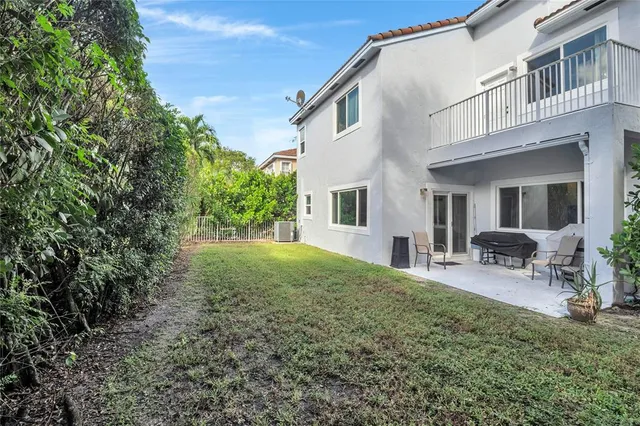 a view of a house with backyard and sitting area