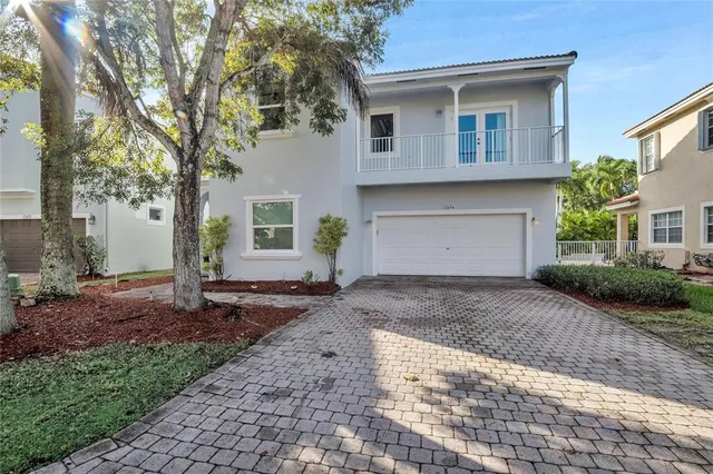 a front view of a house with a yard and a garage