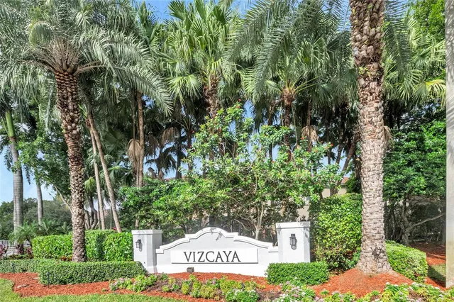 a sign that is sitting in front of a tree