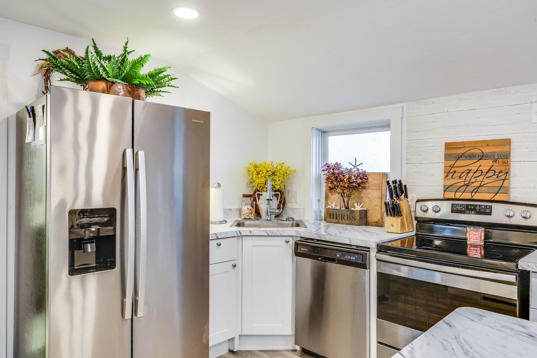 8 Green Street Buzzards Bay, MA 02532 - Photo 18 of 50 a kitchen with stainless steel appliances a refrigerator and a sink