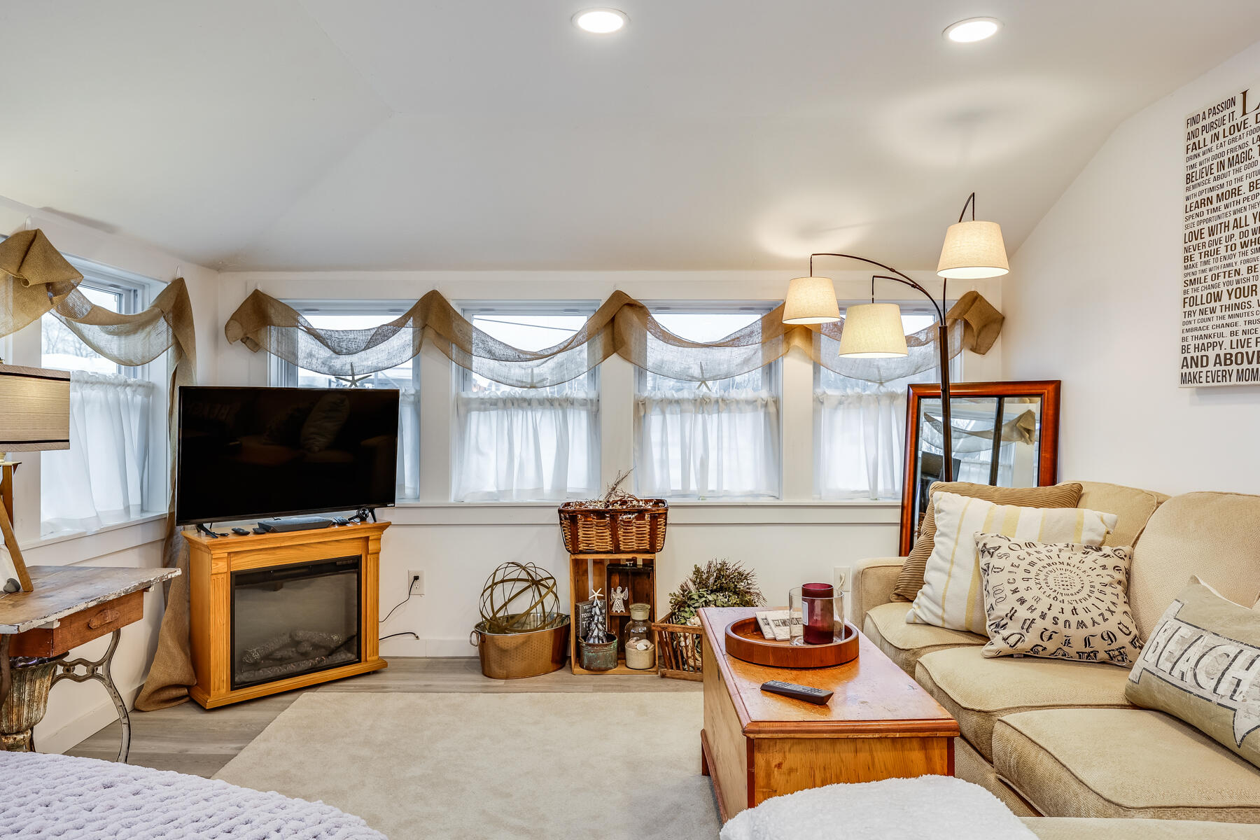 8 Green Street Buzzards Bay, MA 02532 - Photo 6 of 50 a living room with furniture a flat screen tv and a fireplace