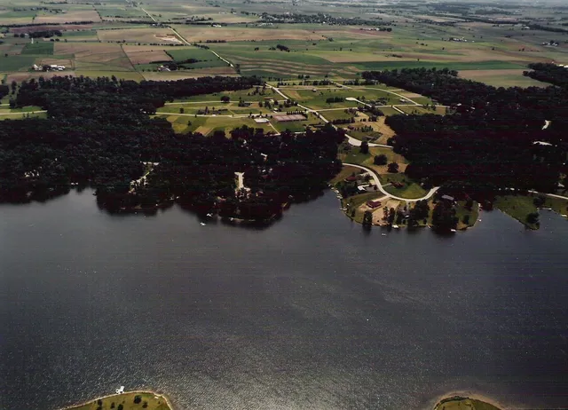 an aerial view of a house with a yard basket ball court and outdoor seating
