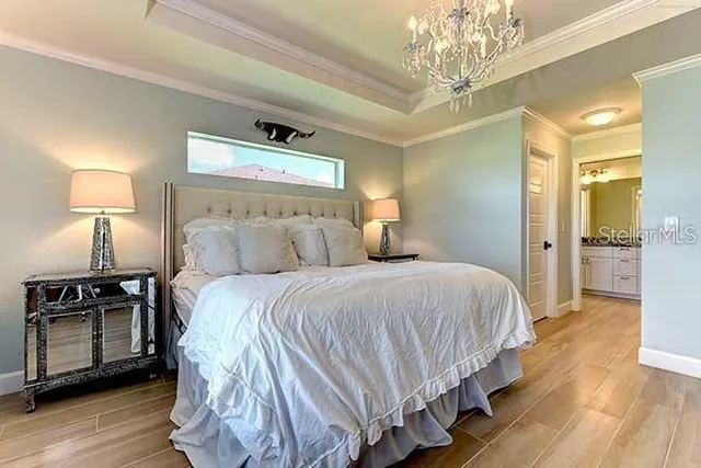 a bedroom with bed and wooden floor