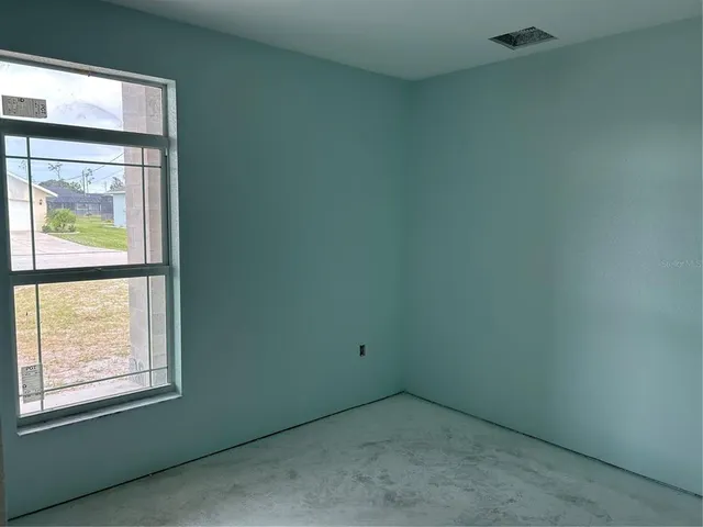 a white toilet sitting in a bathroom next to a window