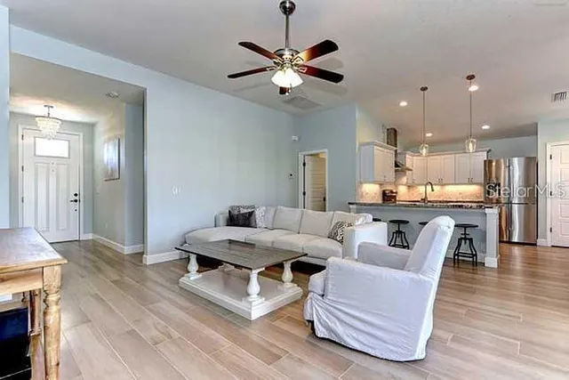 a living room with furniture and kitchen view
