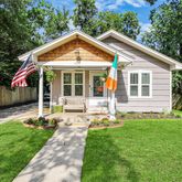 a front view of house with a garden