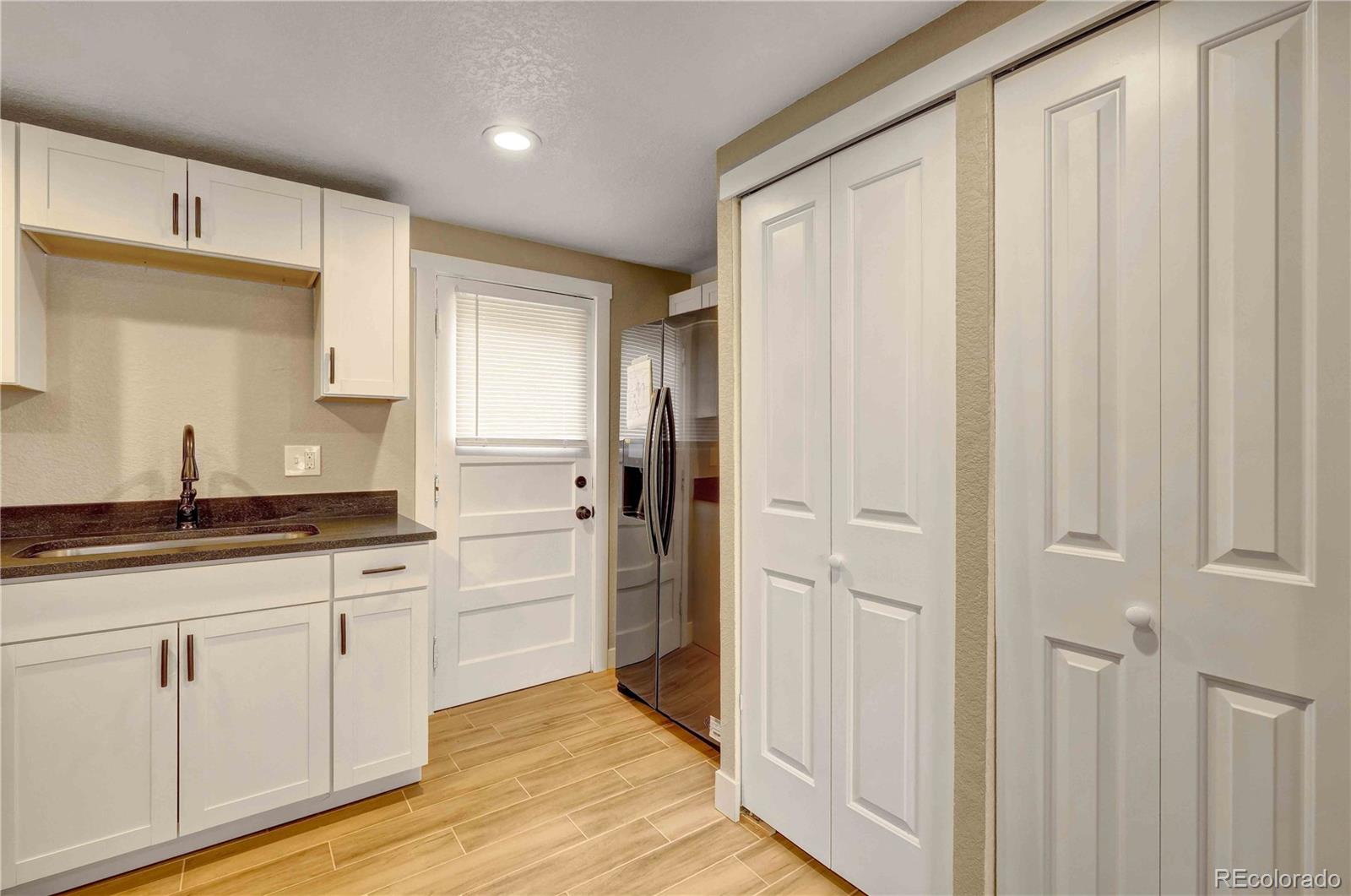 154 South Stuart Street Denver, CO 80219 - Photo 12 of 26 a bathroom with a granite countertop sink and a mirror