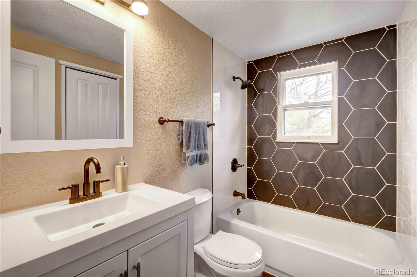 154 South Stuart Street Denver, CO 80219 - Photo 16 of 26 a bathroom with a sink a toilet and shower