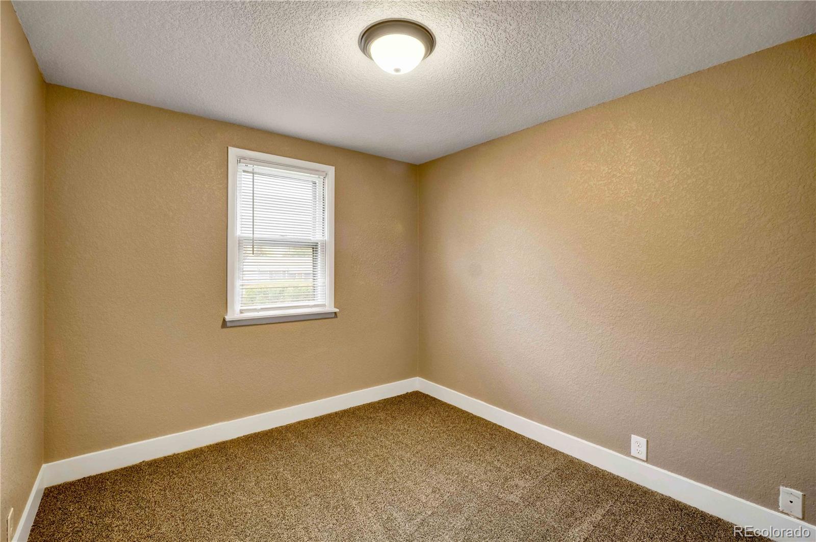 154 South Stuart Street Denver, CO 80219 - Photo 18 of 26 an empty room with a window