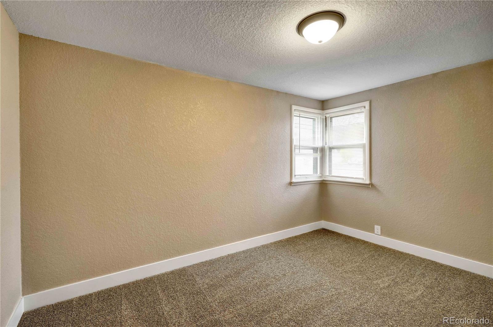 154 South Stuart Street Denver, CO 80219 - Photo 20 of 26 an empty room with a window