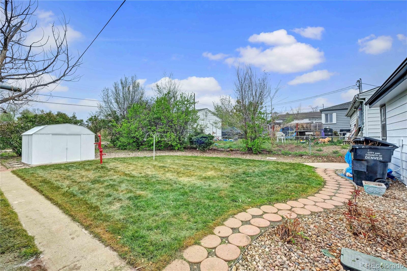 154 South Stuart Street Denver, CO 80219 - Photo 26 of 26 a backyard of a house with table and chairs