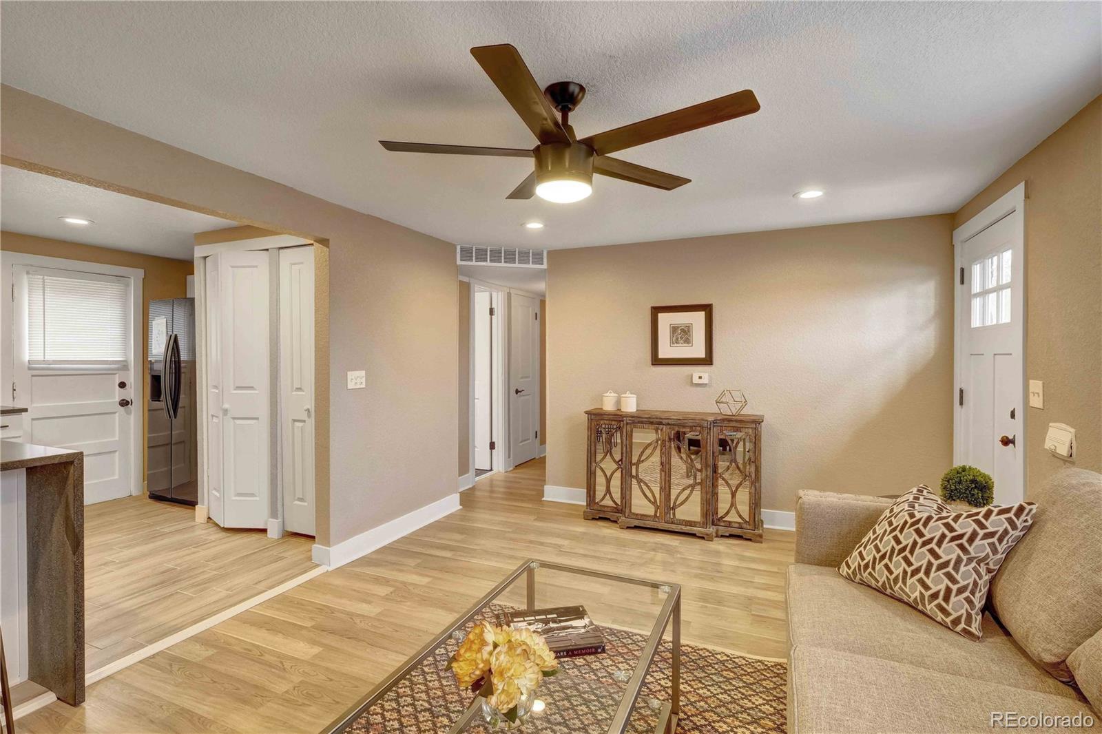 154 South Stuart Street Denver, CO 80219 - Photo 4 of 26 a bedroom with a bed and a couch