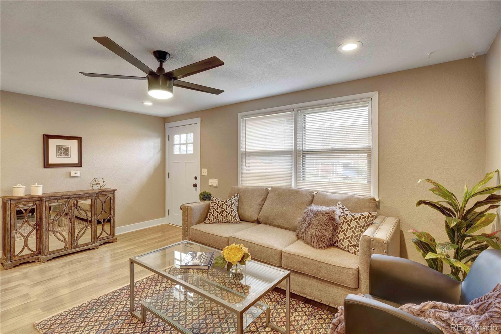 154 South Stuart Street Denver, CO 80219 - Photo 5 of 26 a living room with furniture and a window