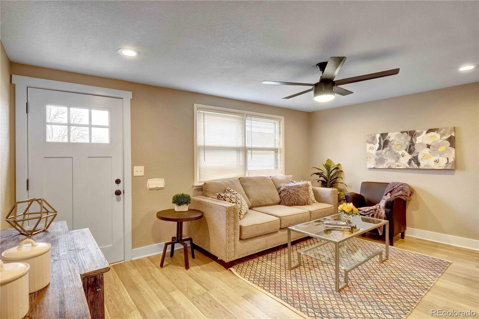 154 South Stuart Street Denver, CO 80219 - Photo 7 of 26 a living room with furniture and a window
