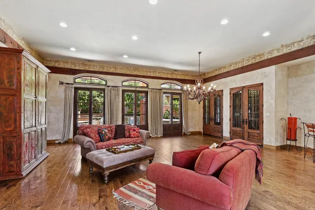 a kitchen with stainless steel appliances kitchen island granite countertop a table chairs sink and cabinets