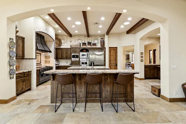 a bed sitting in a spacious bedroom next to a window