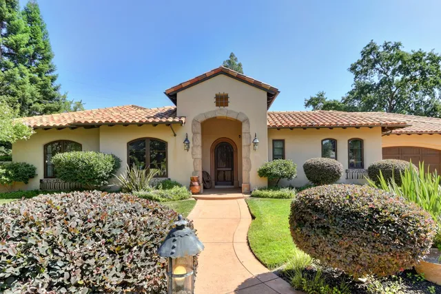 a front view of a house with garden